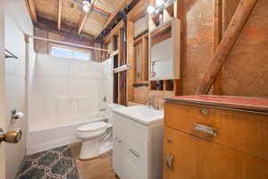 Full bathroom featuring vanity, toilet, and tub / shower combination