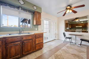 Kitchen featuring electric range, sink, a wealth of natural light, and french doors