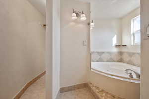 Bathroom featuring tile patterned floors and a bathing tub