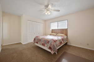 Bedroom featuring carpet flooring, ceiling fan, and a closet