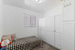 Bedroom featuring carpet and a closet