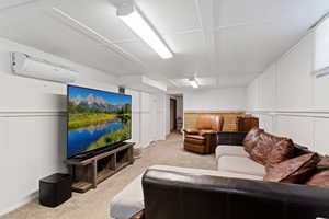 Carpeted living room with a wall unit AC