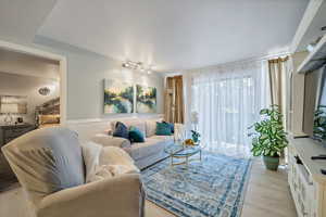 Living room featuring light hardwood / wood-style flooring and track lighting