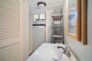 Bathroom with sink, a textured ceiling, and walk in shower