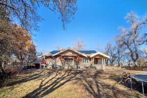 View of front facade featuring solar panels and a trampoline