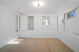 Unfurnished room with light colored carpet