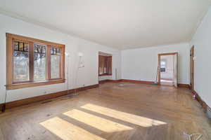 Spare room with hardwood / wood-style floors and crown molding