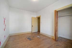 Unfurnished bedroom with a closet and light hardwood / wood-style flooring