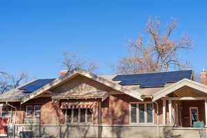 View of front facade with solar panels and central AC