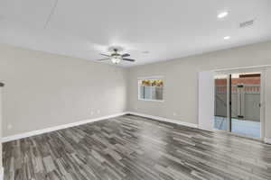 Empty room with ceiling fan and light wood-type flooring