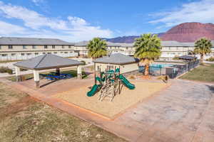 View of play area with a mountain view and a gazebo