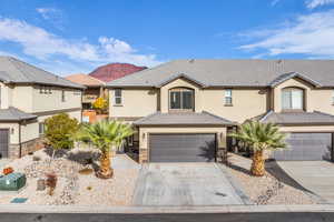 View of front of home with a mountain view and a garage