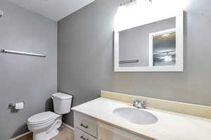 Bathroom with tile patterned floors, vanity, and toilet