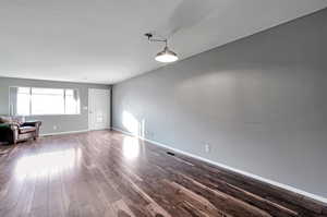 Empty room featuring hardwood / wood-style flooring