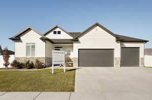 View of front facade with a garage and a front lawn