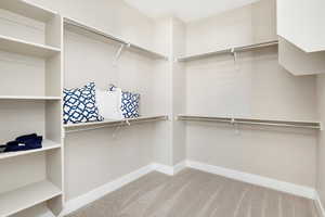 Spacious closet with light colored carpet