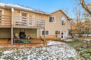 Snow covered property with a balcony