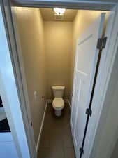 Bathroom with tile patterned flooring and toilet