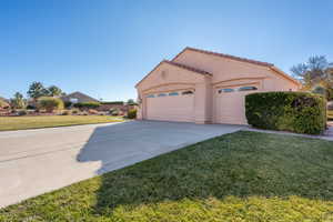 View of home's exterior featuring a yard and a garage