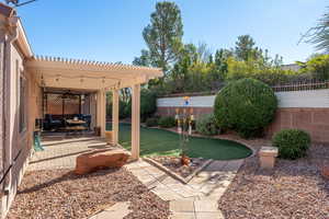 View of yard featuring a pergola, a patio area, and ceiling fan