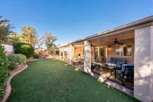 View of yard featuring a patio area, ceiling fan, and outdoor lounge area