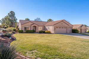 View of front of house featuring a front yard and a garage