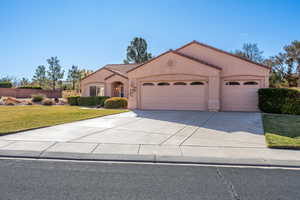 View of front facade with a front yard and a garage