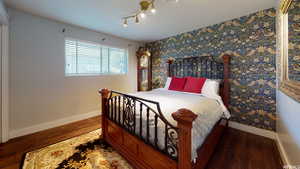 Bedroom with dark wood-type flooring