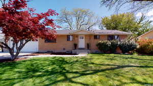 Single story home featuring a front yard