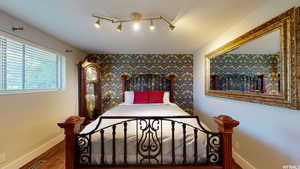 Bedroom featuring hardwood / wood-style floors and rail lighting