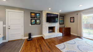 Unfurnished living room featuring a fireplace and dark wood-type flooring