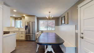 Dining room with a textured ceiling, sink, and a chandelier