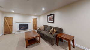 Carpeted living room featuring a brick fireplace