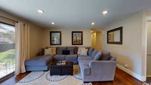 Living room with dark wood-type flooring