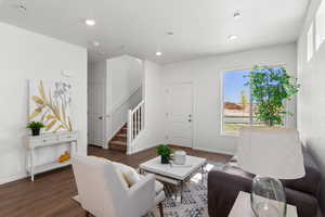 Living room with dark hardwood / wood-style flooring