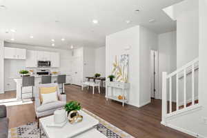 Living room with dark wood-type flooring