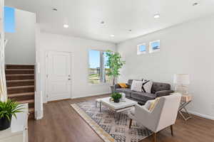 Living room with dark hardwood / wood-style flooring