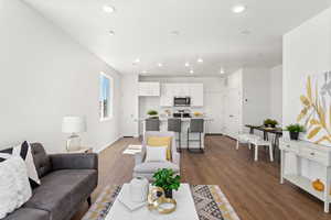 Living room with dark wood-type flooring