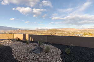 View of yard with a fenced backyard and a mountain view