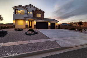 View of front of property with a garage and a balcony