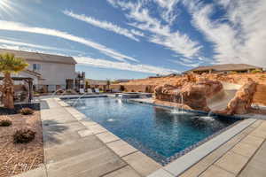 View of pool featuring pool water feature and a patio area