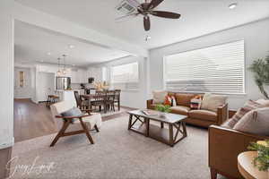 Living room with light hardwood / wood-style floors and ceiling fan