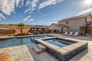 View of pool with a gazebo, a patio area, and an in ground hot tub