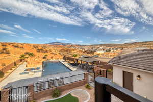 View of pool with a gazebo, a jacuzzi, a mountain view, and a patio