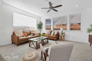 Living room featuring light carpet and ceiling fan