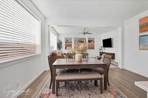 Dining area with ceiling fan and wood-type flooring