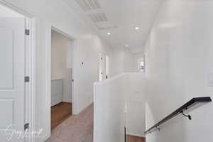 Hallway with light wood-type flooring and washer / dryer