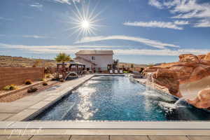 View of pool with a gazebo, a patio area, and pool water feature