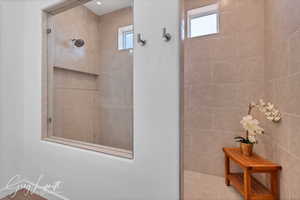 Bathroom with a wealth of natural light and tiled shower