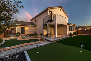 Back house at dusk with a patio